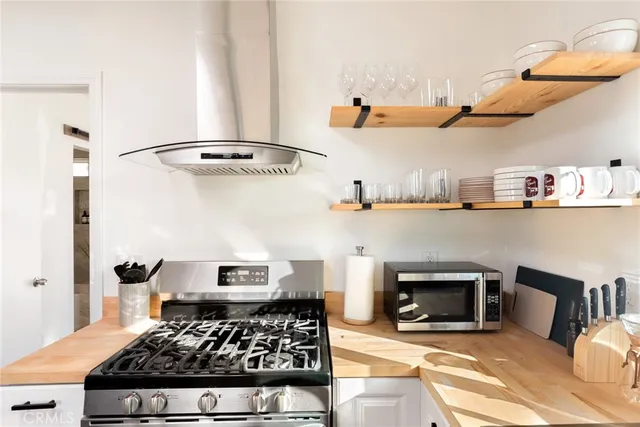 a kitchen with stainless steel appliances granite countertop a stove and a refrigerator