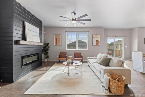 a living room with furniture a fireplace with wooden floor