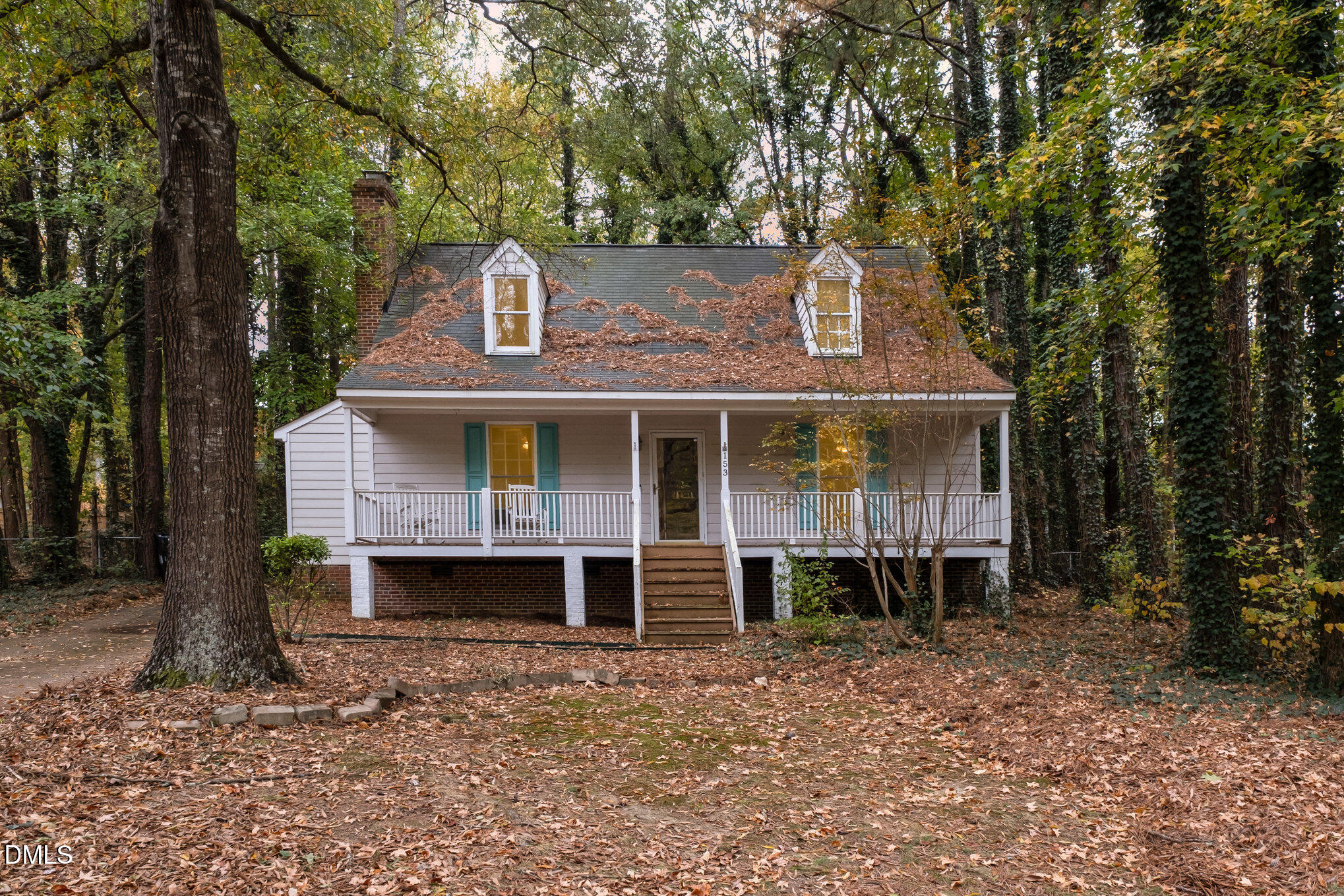 a front view of a house with a yard and balcony