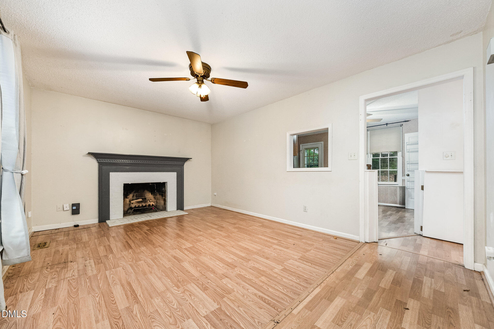 153 Abercrombie Road Wake Forest, NC 27587 - Photo 7 of 18 a view of empty room with wooden floor and fireplace