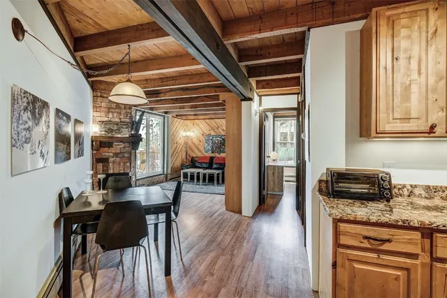 a dining room with furniture and wooden floor
