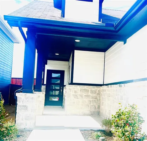 a view of a hallway with a potted plant and a window