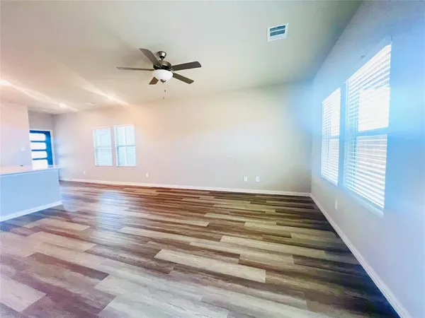 wooden floor in an empty room with a window