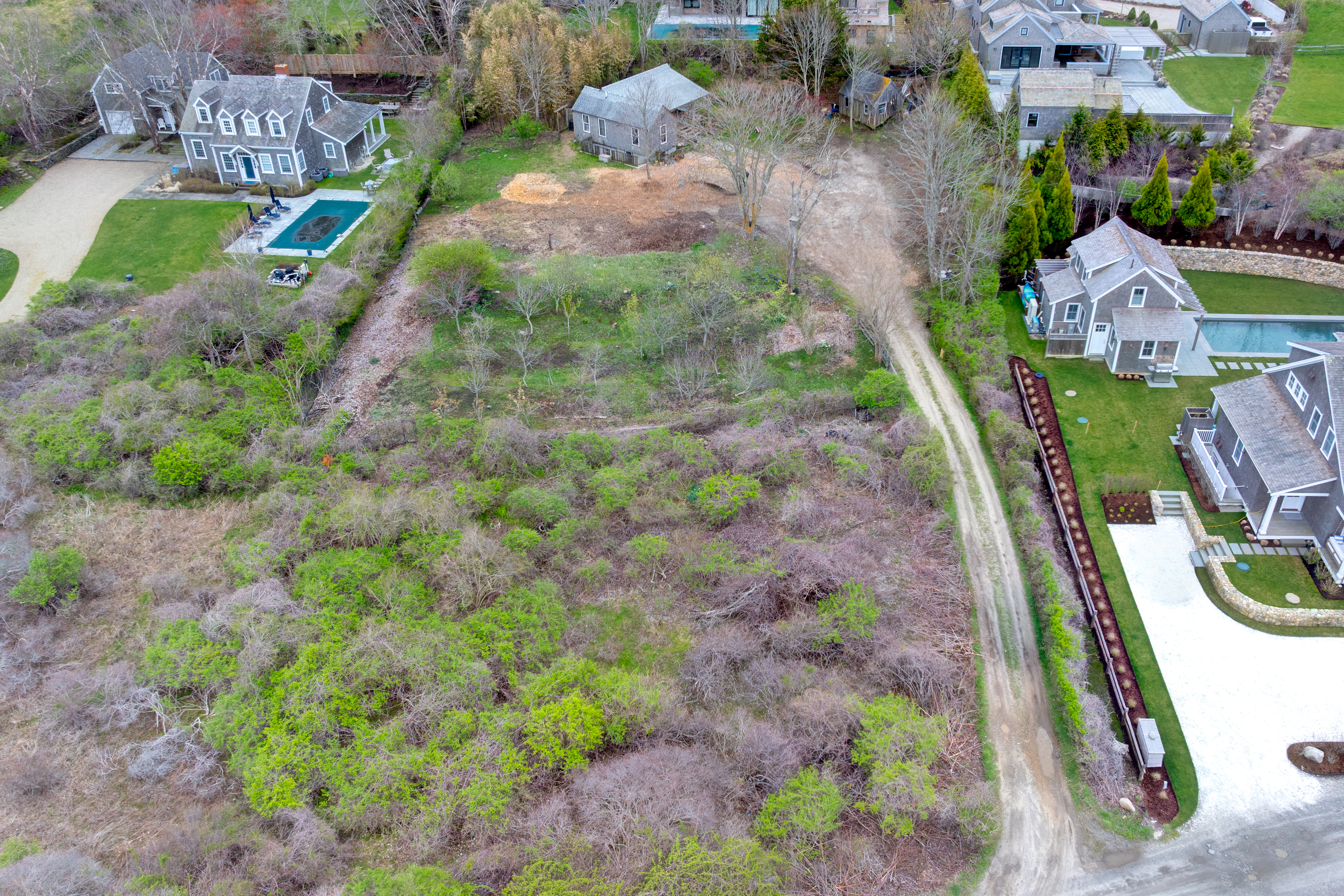 30 Dukes Road Nantucket, MA 02554 - Photo 2 of 4 a backyard of a house with lots of green space and garden