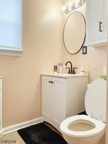 a bathroom with a toilet a sink and a mirror