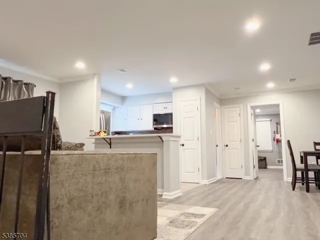 a kitchen with stainless steel appliances kitchen island granite countertop a refrigerator and a sink