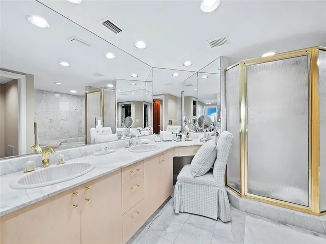 a kitchen with stainless steel appliances a dining table chairs and chandelier