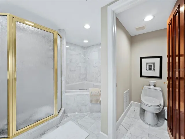 a kitchen with stainless steel appliances kitchen island granite countertop a sink and cabinets