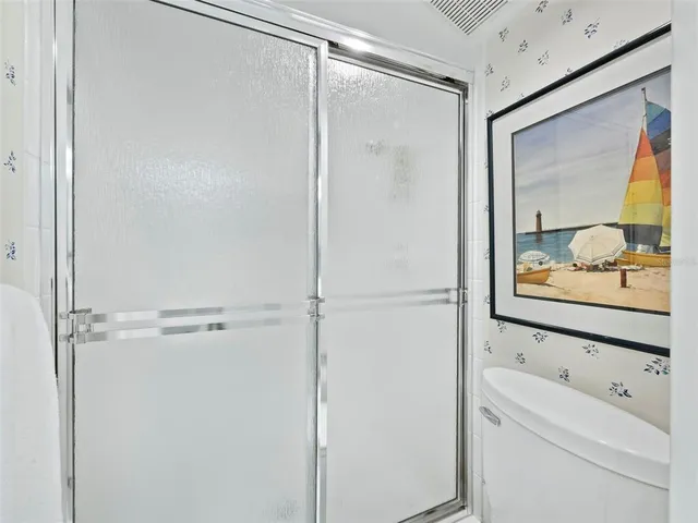 a view of swimming pool with outdoor seating and lots of trees in the background