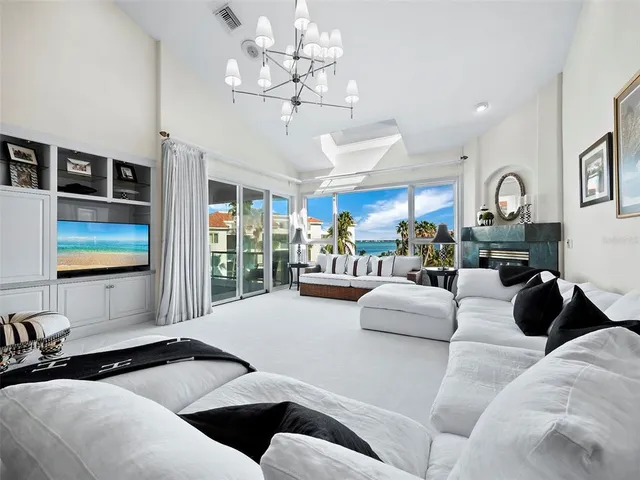 a living room with furniture and a floor to ceiling window