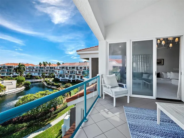 a large white bed sitting in a room next to a window