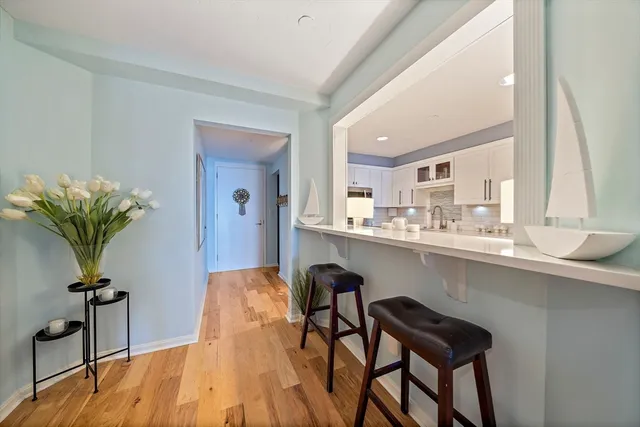 a bedroom with a bed and a flat tv screen on the dresser