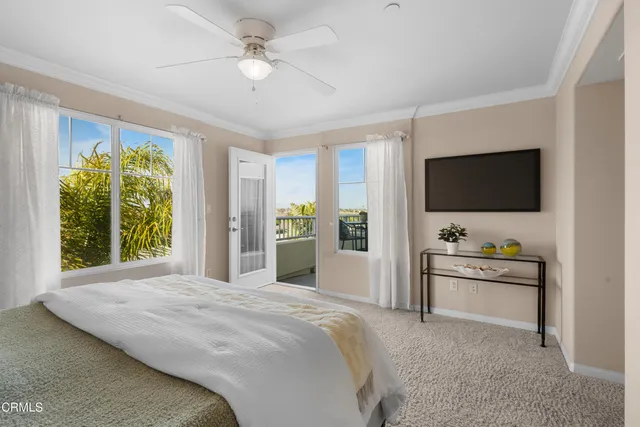 a spacious bedroom with a large bed and a flat screen tv