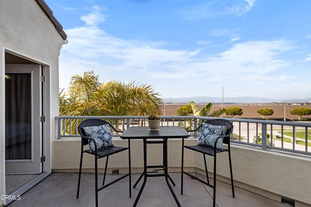 a view of a chairs and table in patio
