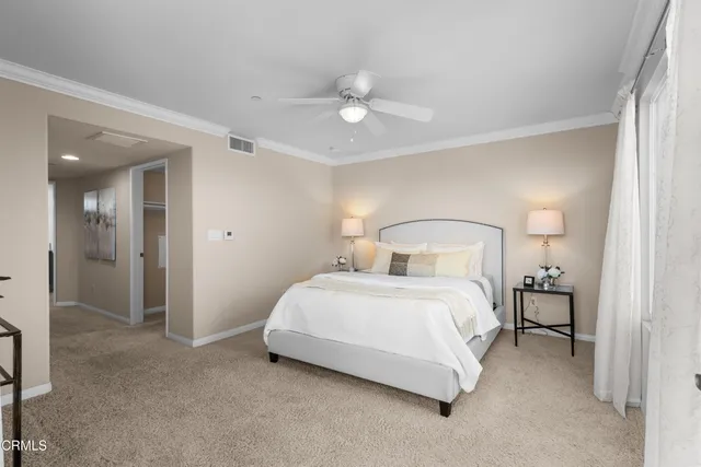 a spacious bedroom with a bed and a chandelier