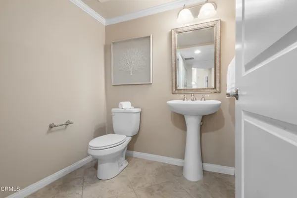 a bathroom with a sink toilet and a mirror