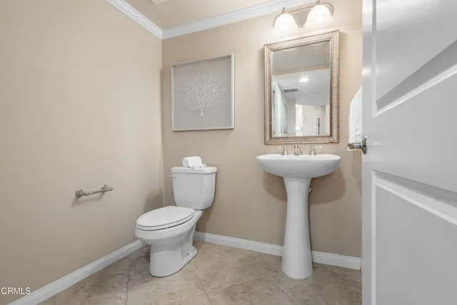 a bathroom with a sink toilet and a mirror