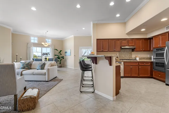 a living room with furniture and kitchen view