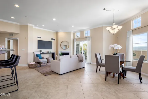 a dining room with furniture a livingroom and chandelier