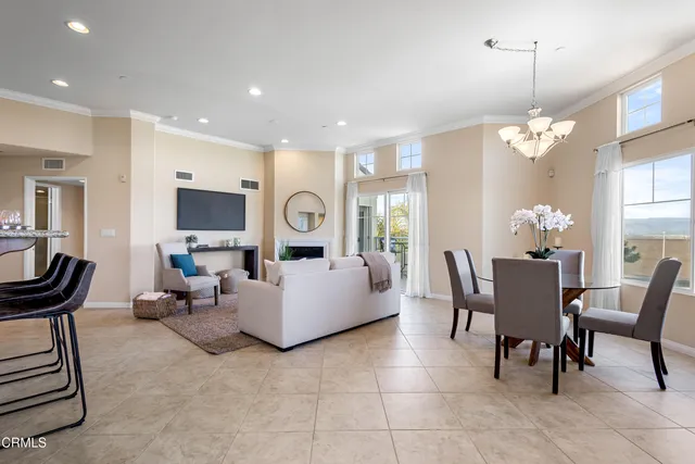 a dining room with furniture a livingroom and chandelier