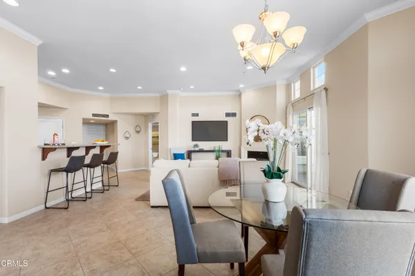 a view of a dining room with furniture and a chandelier