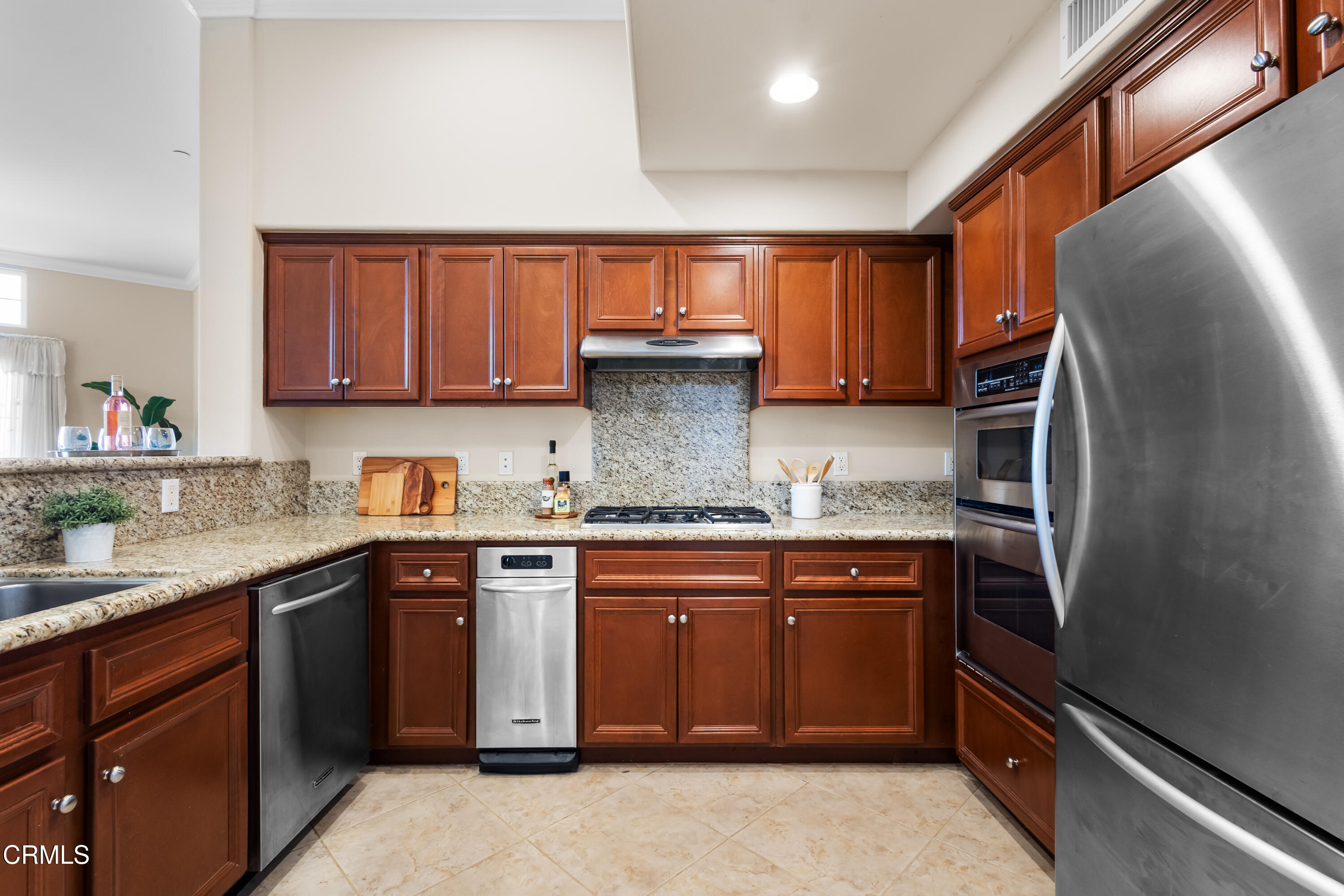 4282 Tradewinds Drive Oxnard, CA 93035 - Photo 7 of 29 a kitchen with granite countertop stainless steel appliances and wooden cabinets
