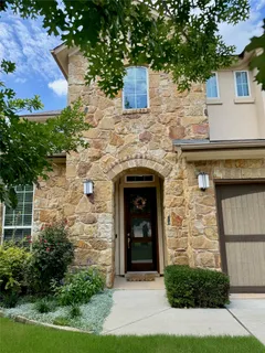front view of a stone house with a small yard