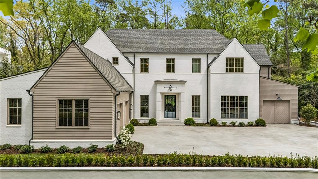 3167 Rilman Road Northwest Atlanta, GA 30327 - Photo 1 of 52 a front view of a house with a yard