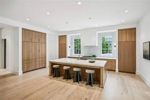 a kitchen with stainless steel appliances granite countertop a stove and a wooden floors