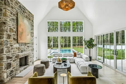 a living room with furniture and a floor to ceiling window
