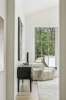 a spacious bedroom with a bed and a large window