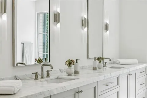 a bathroom with double sink and a mirror