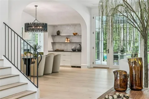 a dining room with wooden floor and windows