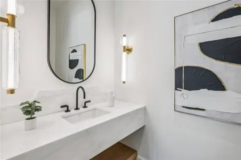 a living room with fireplace furniture and a large window