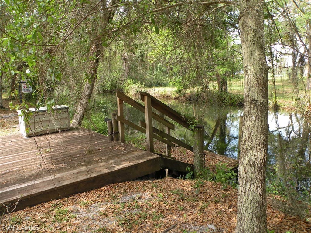 17571 Frank Road Alva, FL 33920 - Photo 12 of 13 a view of a wooden deck and trees
