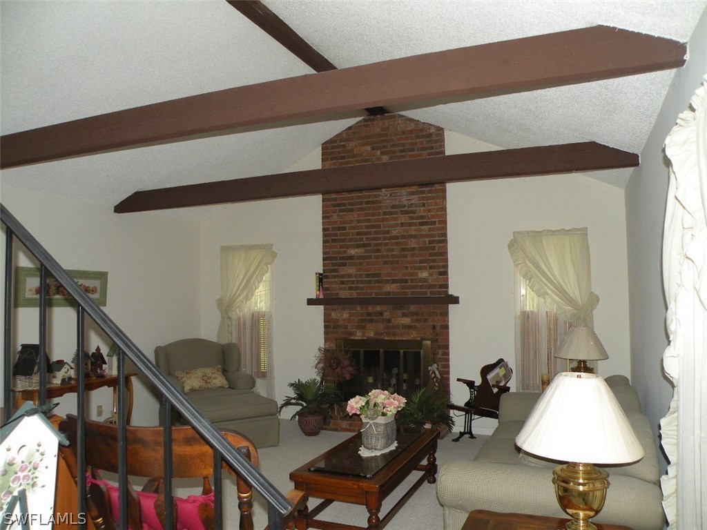 17571 Frank Road Alva, FL 33920 - Photo 3 of 13 a living room with furniture and a fireplace