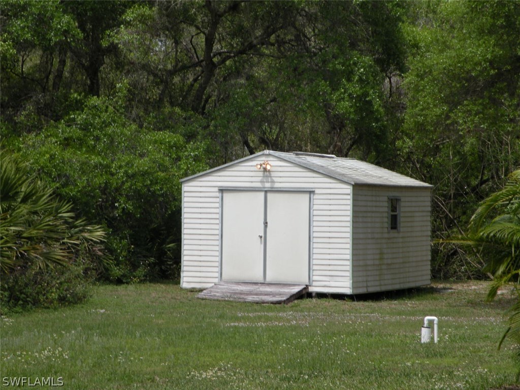 17571 Frank Road Alva, FL 33920 - Photo 7 of 13 a view of a small house with a yard