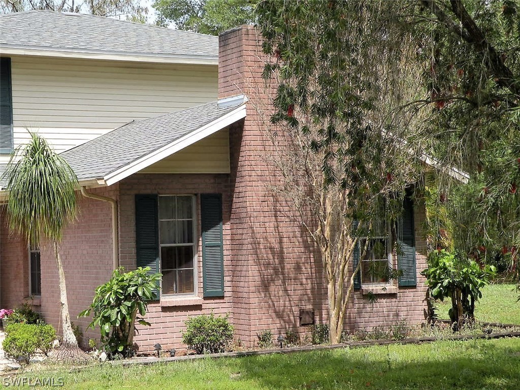 17571 Frank Road Alva, FL 33920 - Photo 8 of 13 front view of a house with a garden