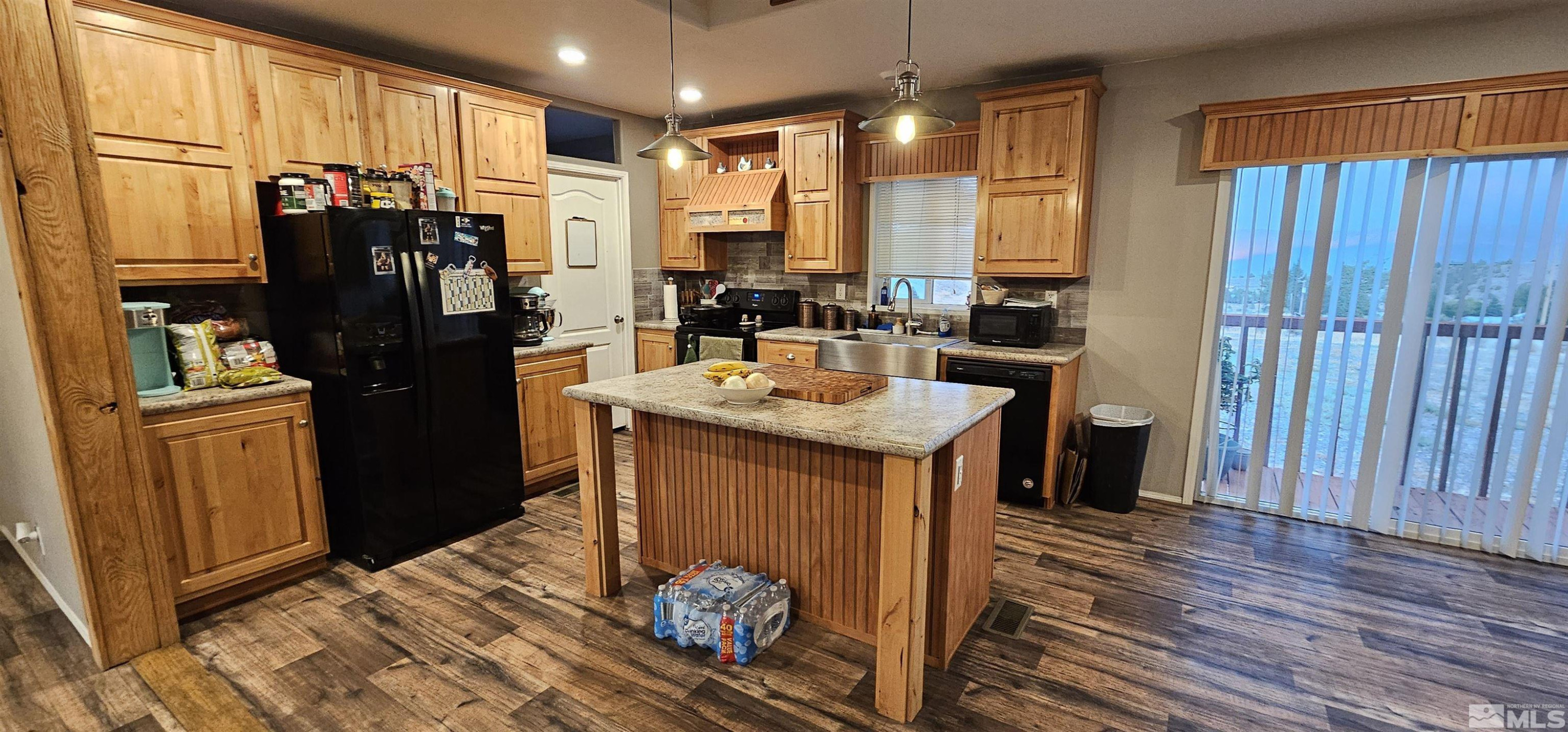 116 Victorine Drive Kingston, NV 89310 - Photo 12 of 25 a kitchen with stainless steel appliances granite countertop a refrigerator and a sink