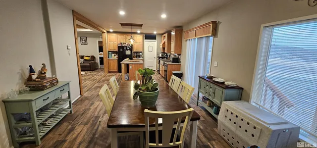a kitchen with stainless steel appliances a stove a table and chairs