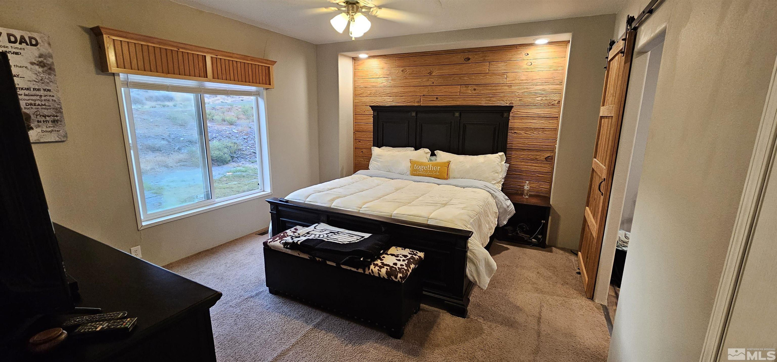 116 Victorine Drive Kingston, NV 89310 - Photo 16 of 25 a bed sitting in a bedroom next to a window