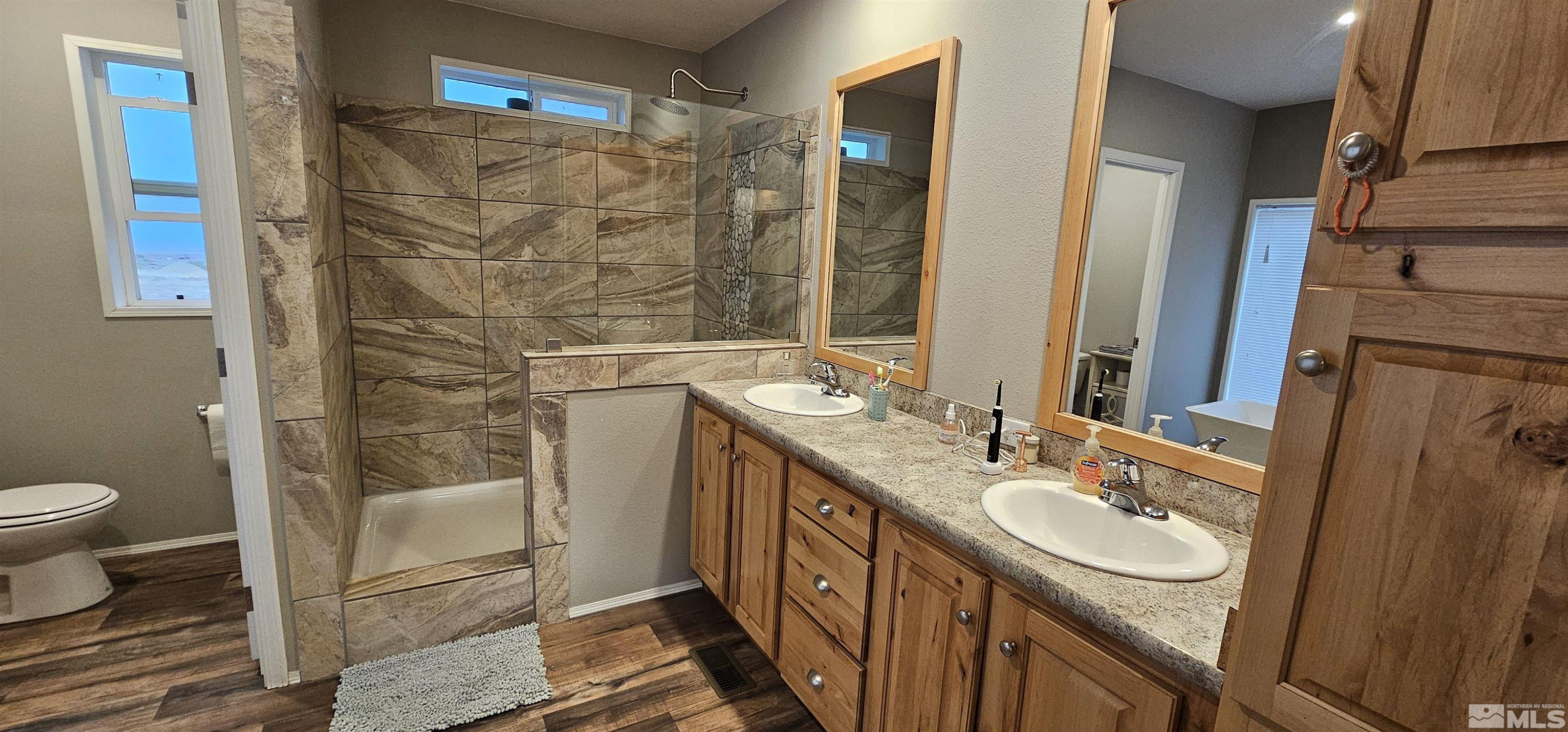 116 Victorine Drive Kingston, NV 89310 - Photo 18 of 25 a bathroom with a double vanity sink toilet and shower