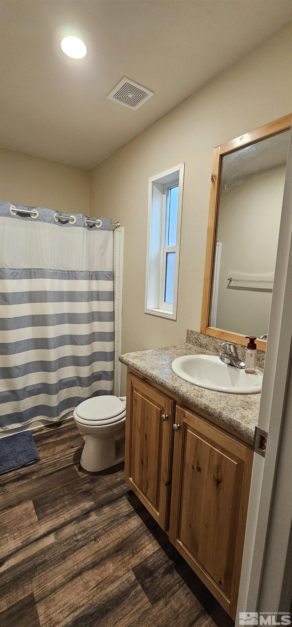 116 Victorine Drive Kingston, NV 89310 - Photo 23 of 25 a bathroom with a granite countertop toilet sink and mirror