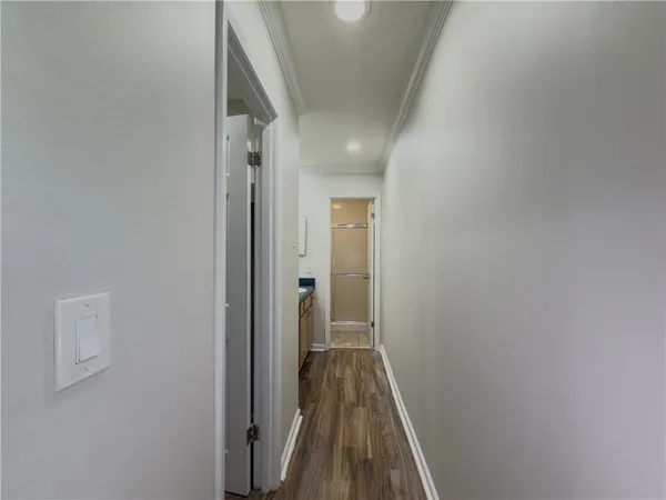 a view of a hallway with wooden floor
