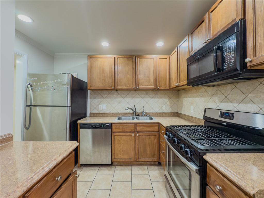 3301 Henderson Mill Road, Unit D3 Atlanta, GA 30341 - Photo 9 of 32 a kitchen with stainless steel appliances granite countertop a stove a refrigerator and a sink