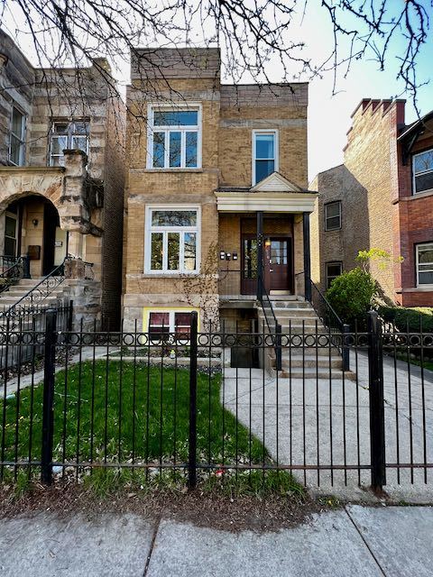 a view of a brick house with many windows