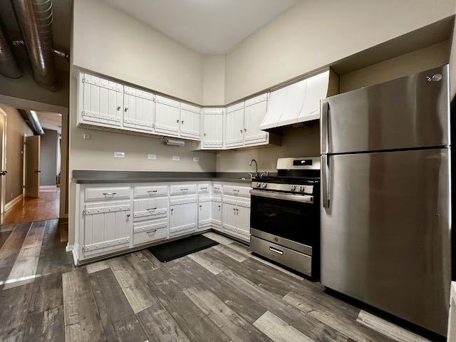 Undisclosed Address Chicago, IL 60647 - Photo 24 of 31 a kitchen with stainless steel appliances a refrigerator stove and cabinets