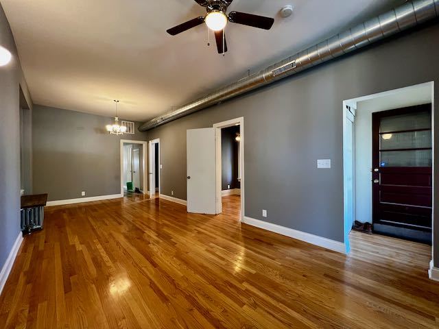 Undisclosed Address Chicago, IL 60647 - Photo 6 of 31 a view of an empty room with wooden floor