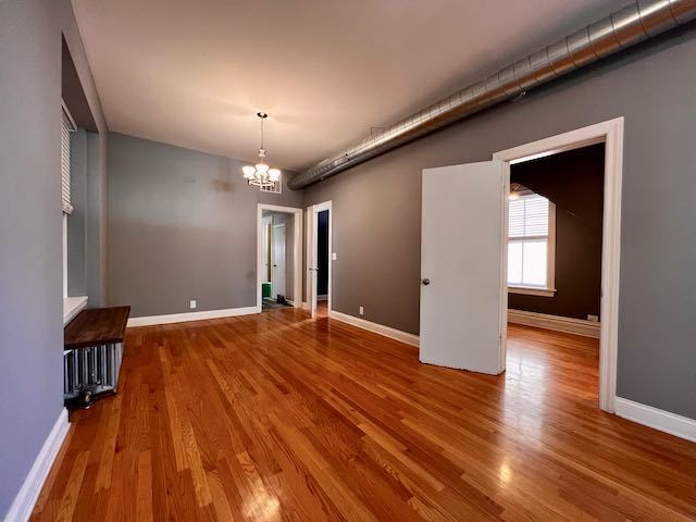 Undisclosed Address Chicago, IL 60647 - Photo 7 of 31 a view of an empty room with wooden floor and a window