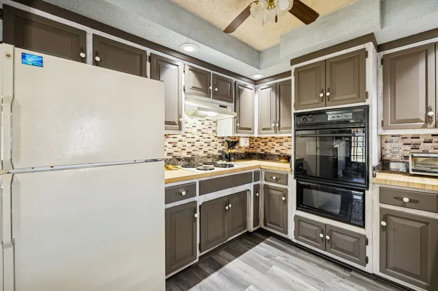 a kitchen with stainless steel appliances a refrigerator sink and cabinets
